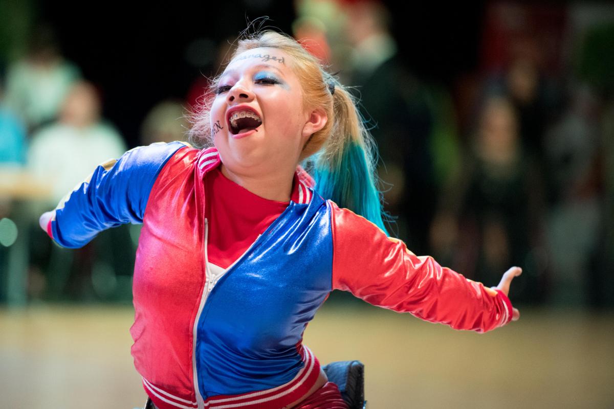 Young Mexican female athlete dances in her wheelchair