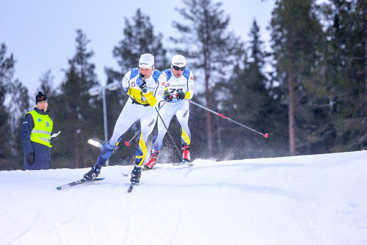 Swedish vision impaired skier follows behind his guide