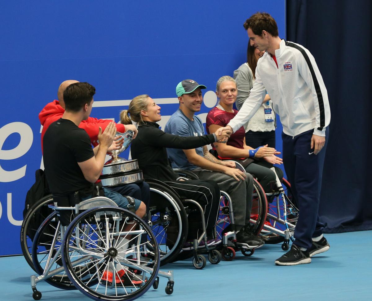Able bodied tennis player Andy Murray shakes hands with a number of wheelchair tennis players