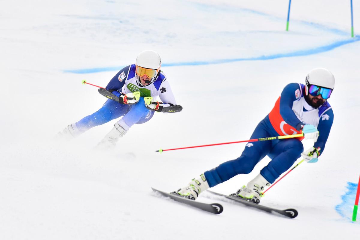 Jon Santacana Maiztegui - Alpine Worlds 2019 male vision impaired Para alpine skier Jon Santacana Maiztegui skies through a gate following his guide skier