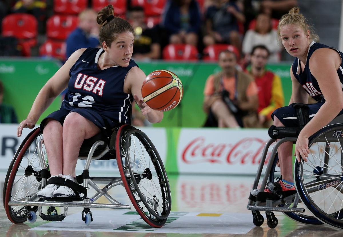 female wheelchair basketballer Rebecca Murray dribbles the ball on court