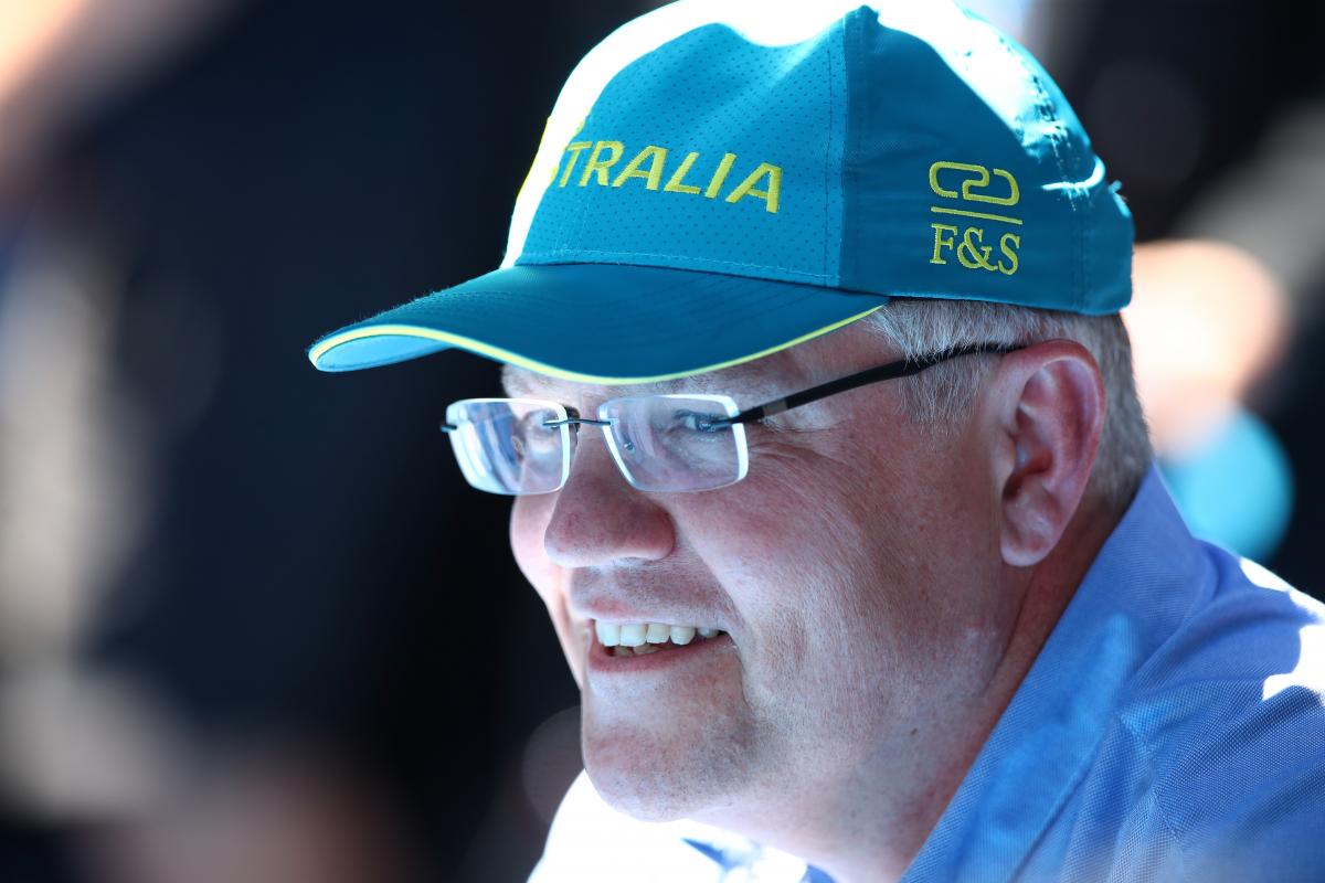 Scott Morrison wearing an Australia baseball cap and smiling