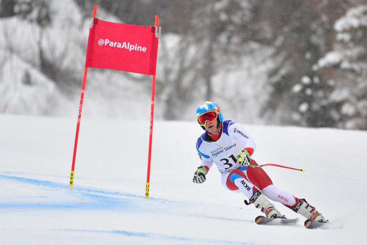 male Para alpine standing skier Theo Gmur skis round a gate