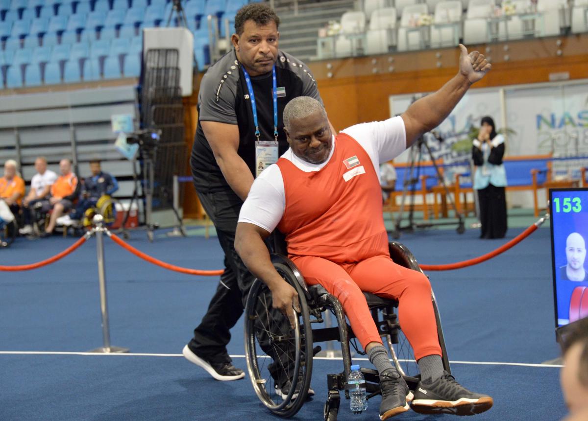male Para powerlifter Mohammed Khamis Khalaf gives a thumbs up and smiles