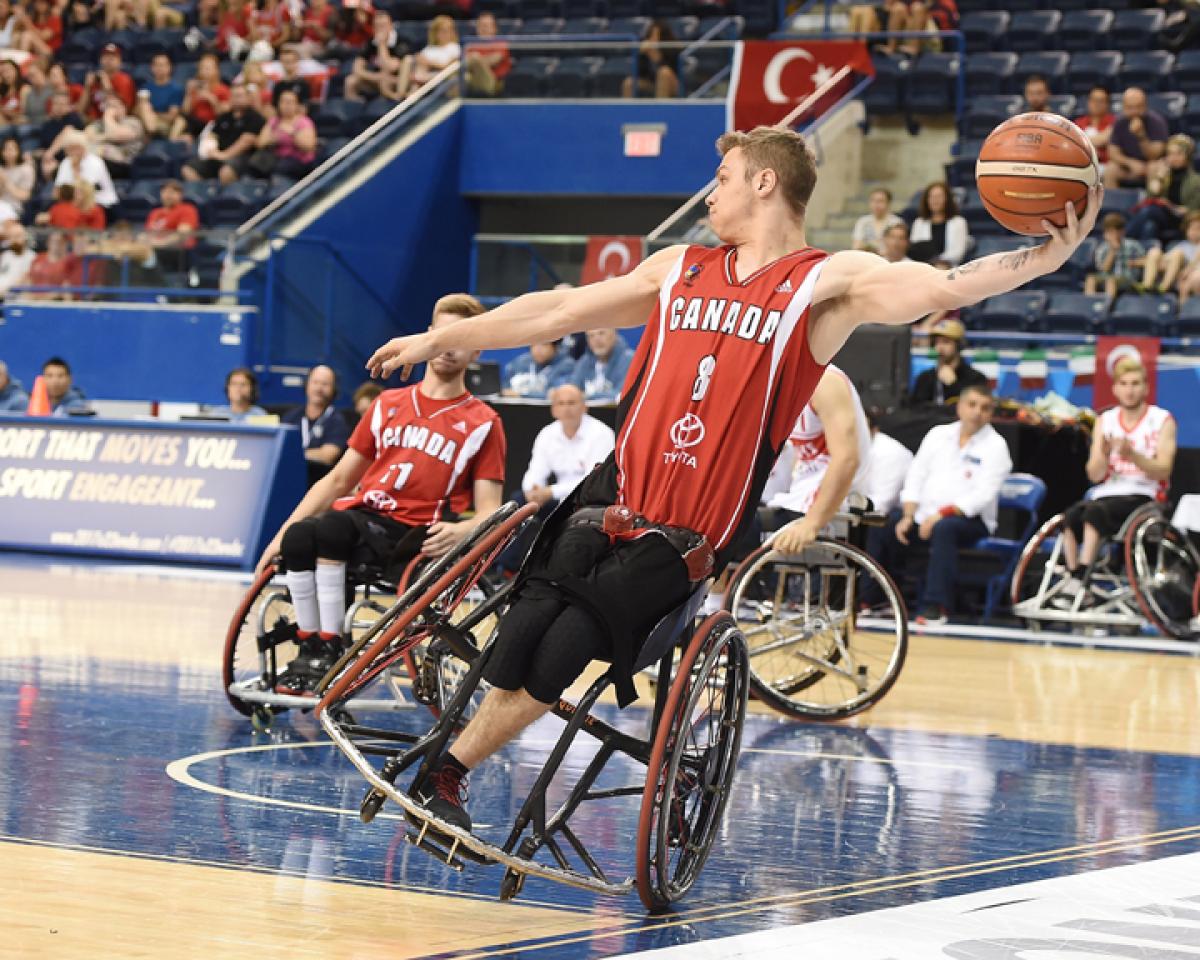 male wheelchair basketballer Liam Hickey tilts sideways as he prepares to throw the ball