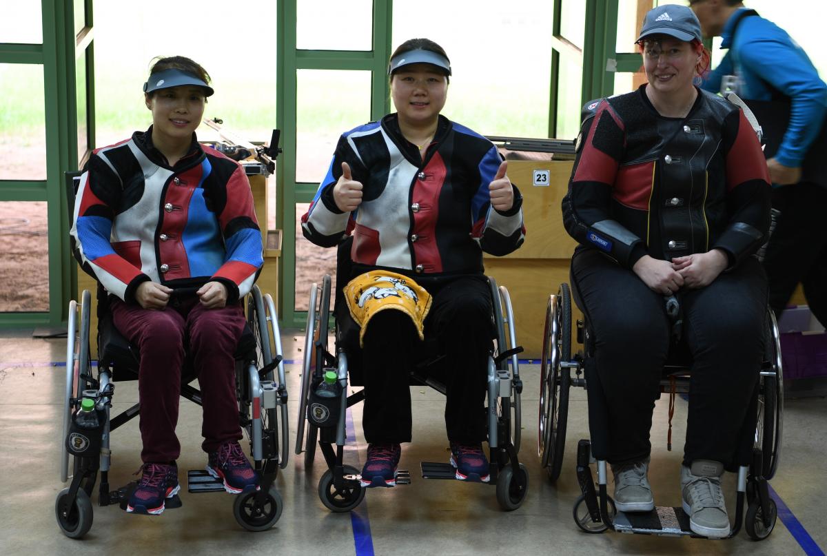 three female Para shooters with Zhang Cuiping giving a thumbs up