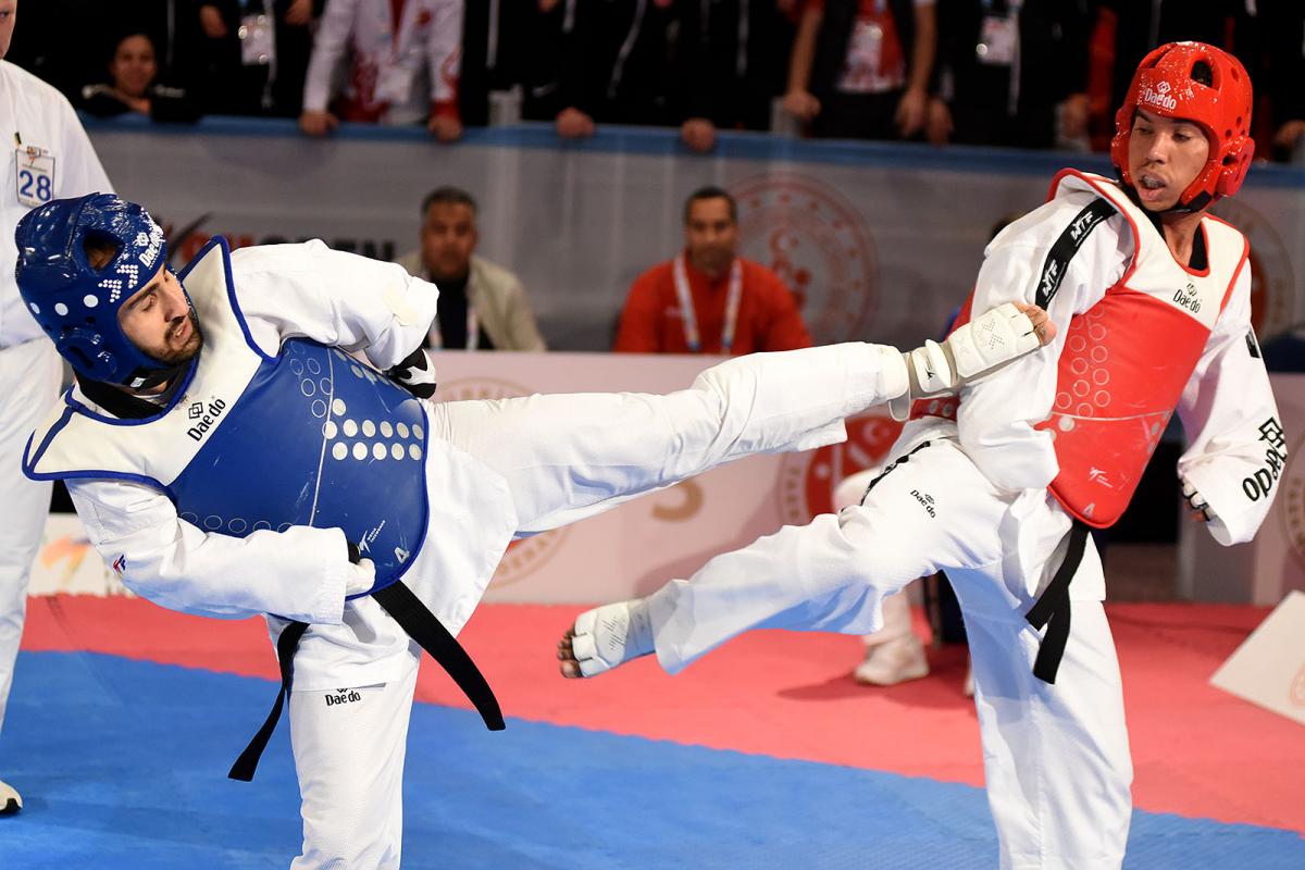 male Para taekwondo fighter Rachid Ismaili Alaoui kicks another fighter in the chest