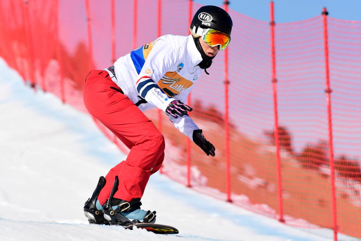 A female Para snowboarder competing