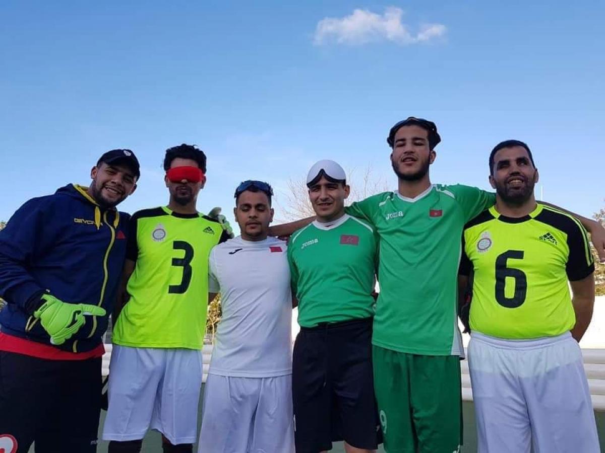 Oman blind football a group of five blind footballers from Oman smiling down at the camera