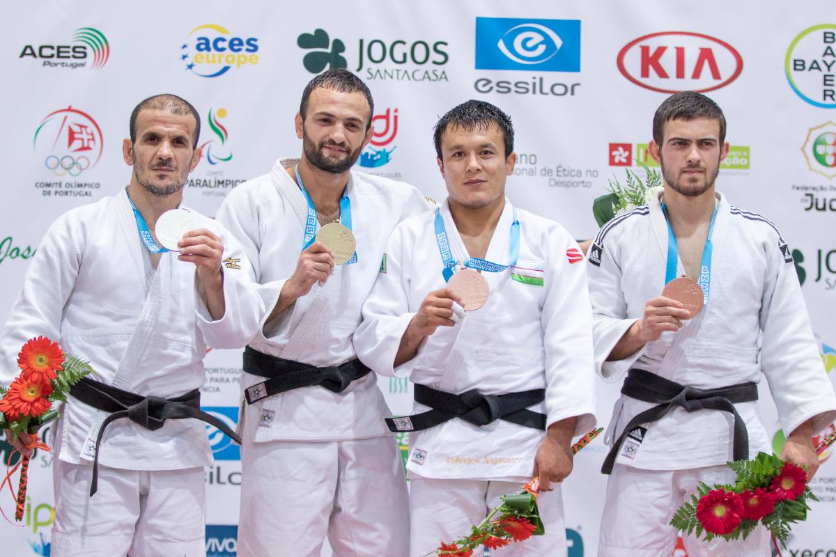 Giorgi Gamjashvili four male judokas on the podium with their medals, with Giorgi Gamjashvili on the end holding bronze
