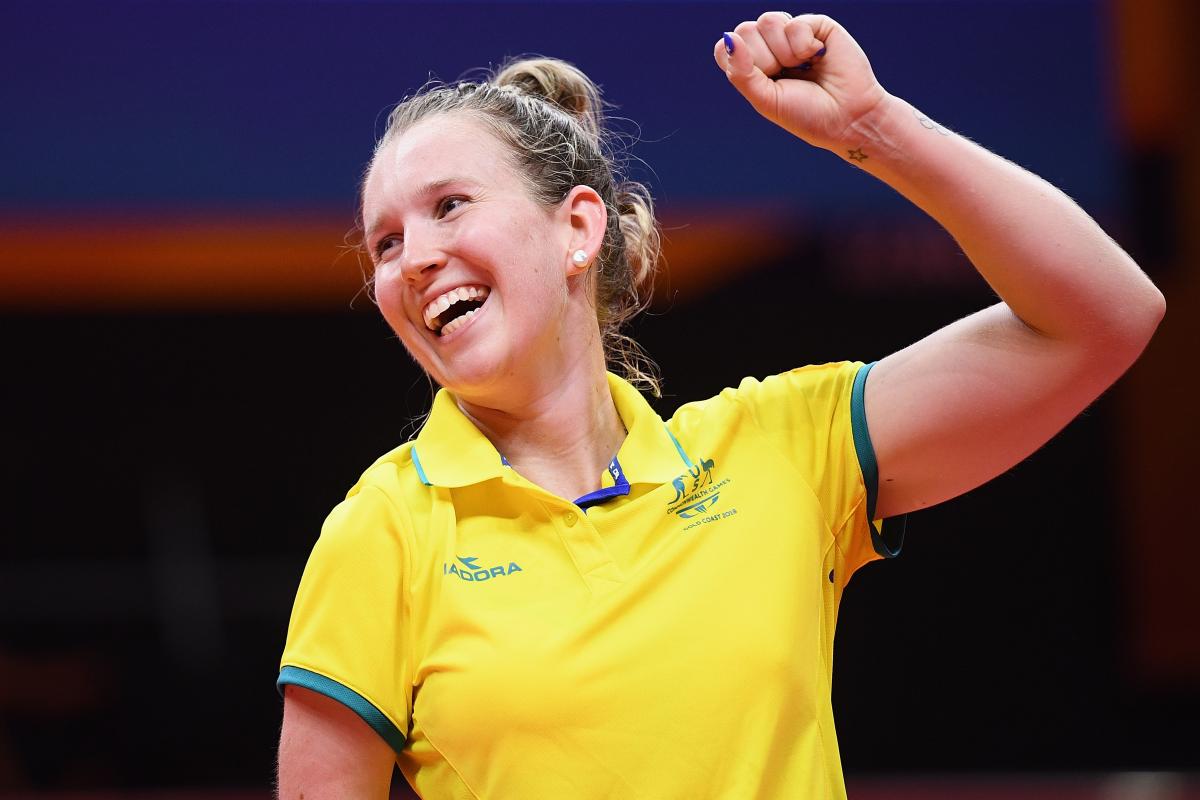 female Para table tennis player Melissa Tapper pumps her fist in victory