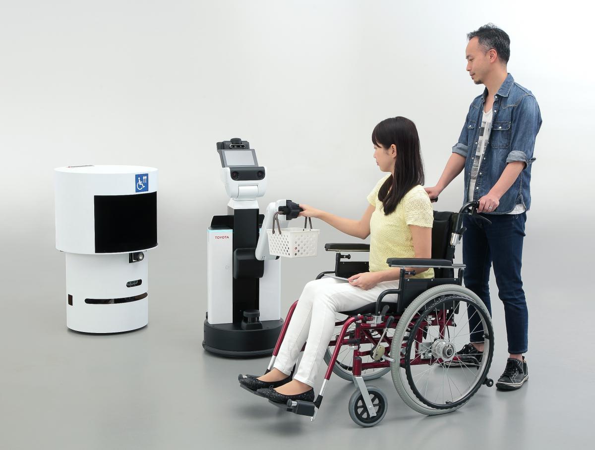 a person in a wheelchair having their basket held by a robot