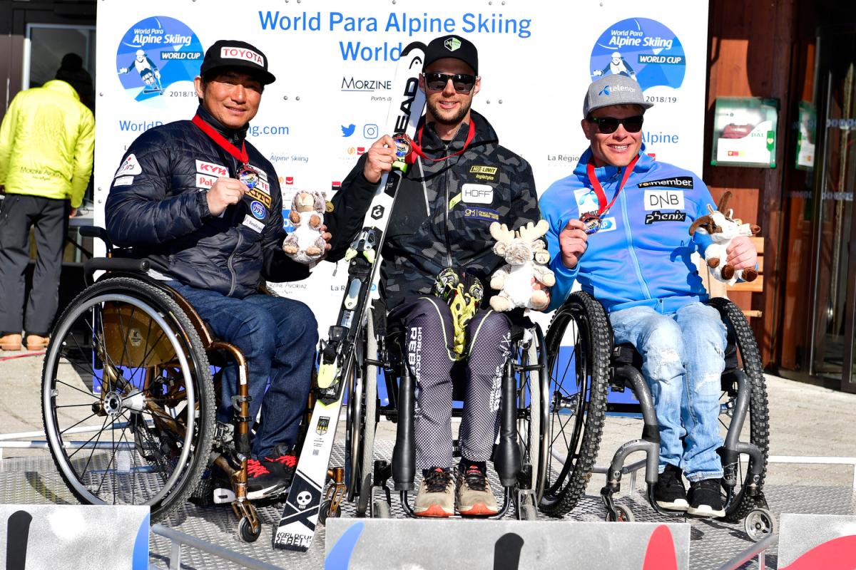 male Para alpine sit skier Igor Sikorski on the podium