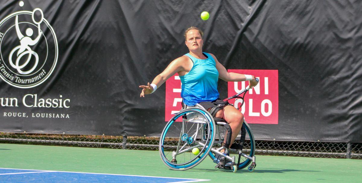 female wheelchair tennis player Aniek van Koot plays a backhand on a hard court 