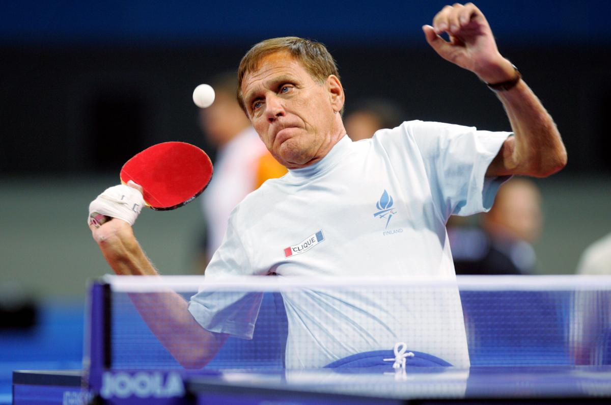 male Para table tennis player Matti Launonen plays a forehand