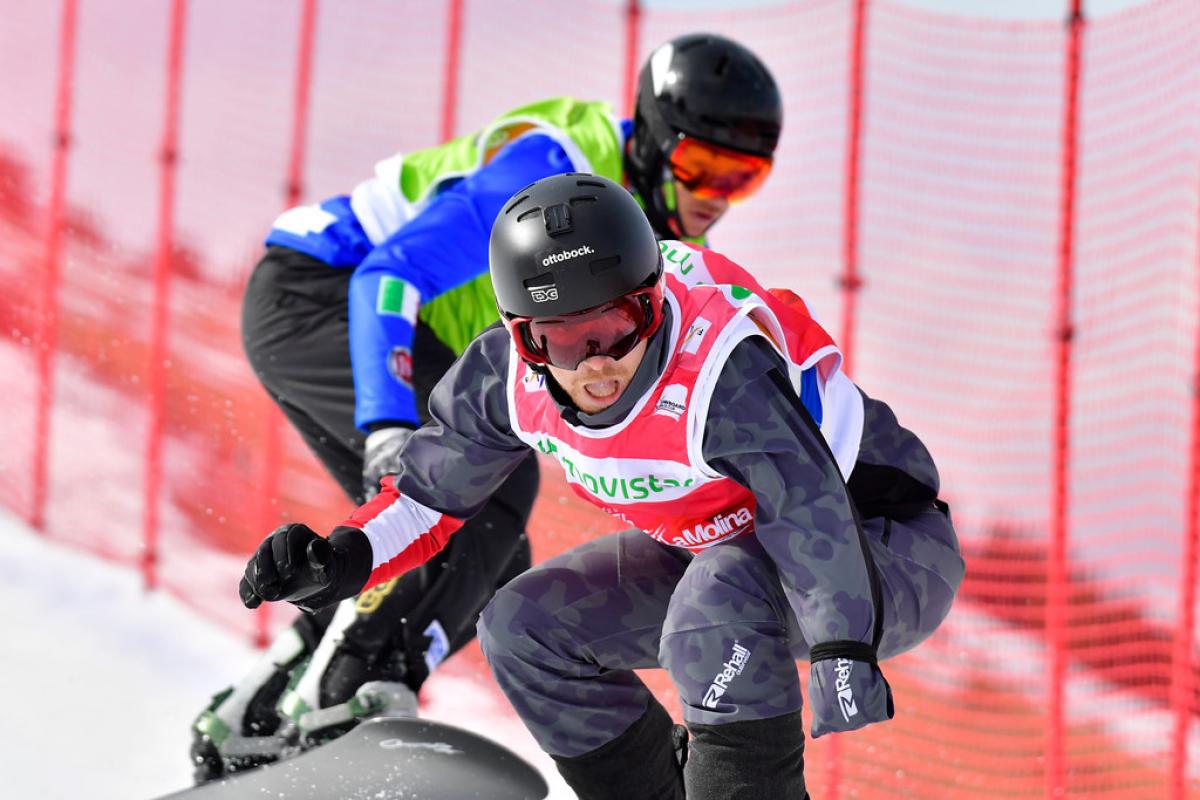 Patrick Mayrhofer - La Molina 2019 male Para snowboarder Patrick Mayrhofer rides in front of another snowboarder