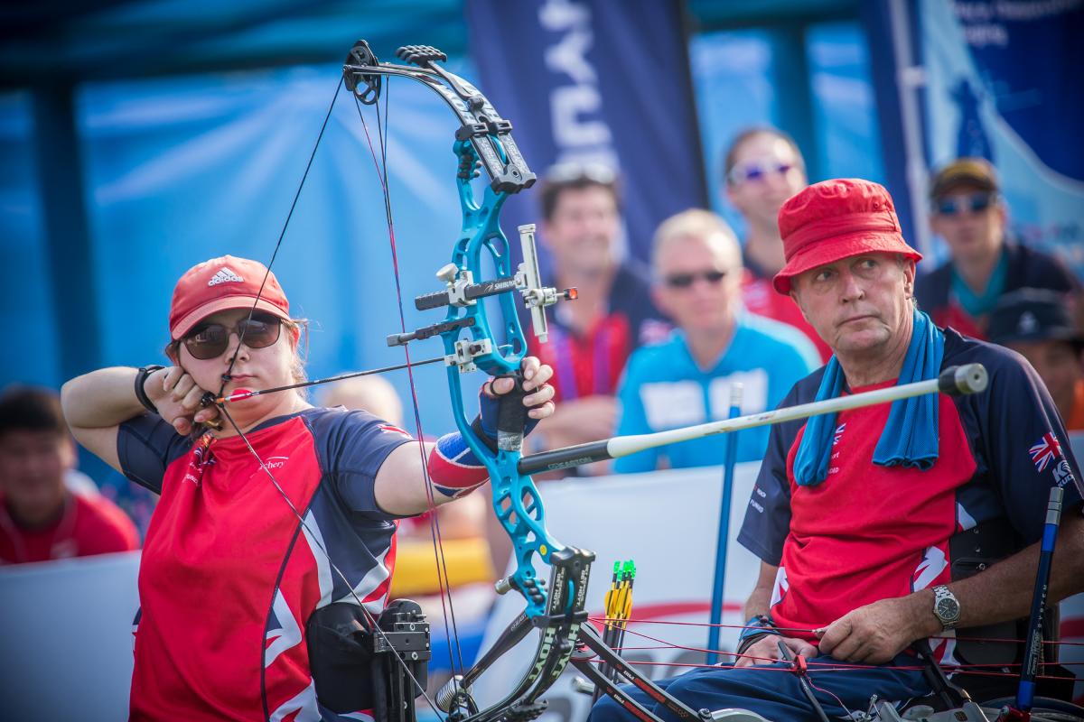 female Para archer Jessica Stretton prepares to shoot an arrow