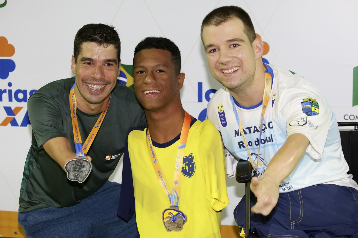 Gabriel Geraldo dos Santos - Sao Paulo 2019 three male Para swimmers with their medals on the podium