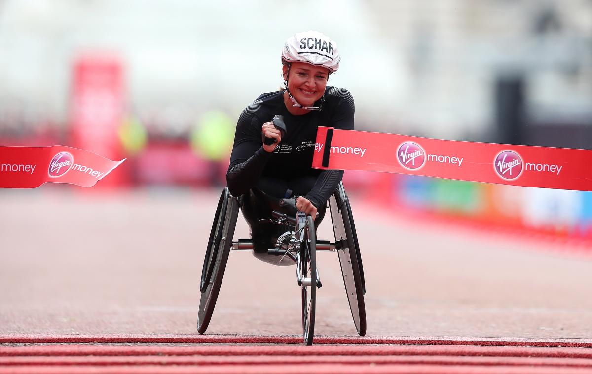 Female wheelchair racer Manuela Schaer breaks the tape at the finish line