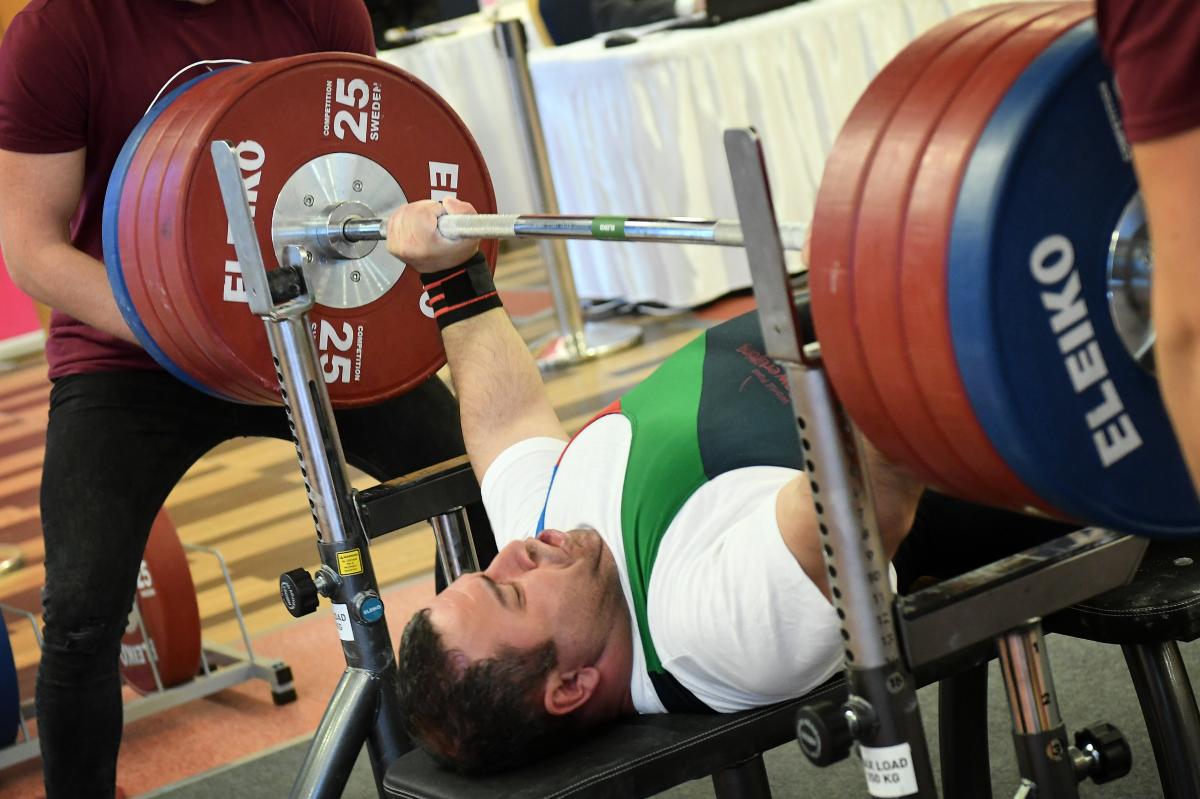 male Para powerlifter Elshan Huseynov prepares to lift the bar