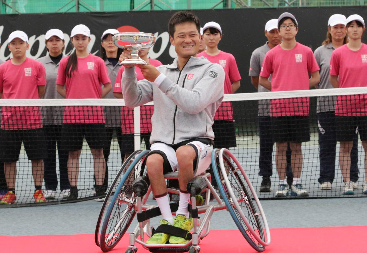 Shingo Kunieda - Japan Open male wheelchair tennis player Shingo Kunieda smiling and holding up a silver trophy
