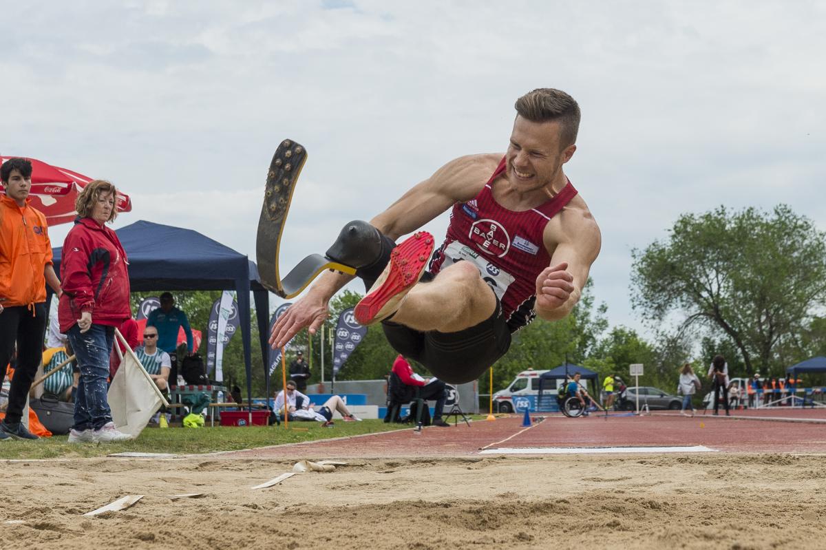 A man with a prosthetic leg competing in long jump