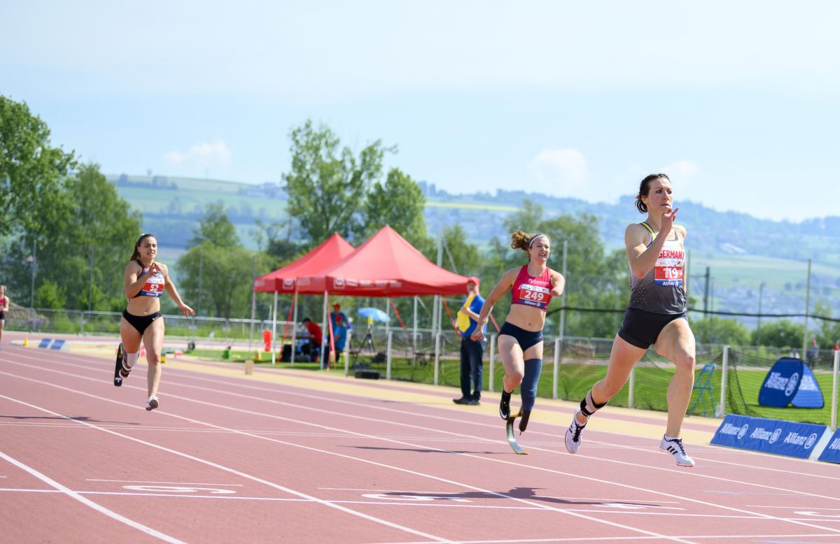 German female sprinter leads ahead of three other runners