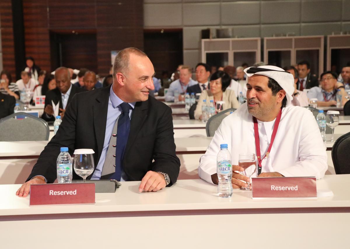 IPC Vice President Duane Kale and Governing Board member Mohammed Alhameli Two men talking to each other at a conference