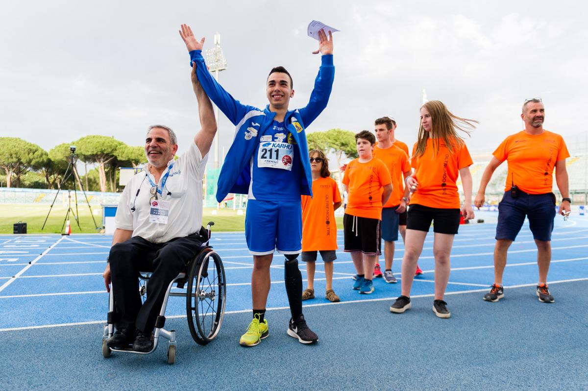 male Para athlete Lorenzo Marcantognini celebrates waving on the podium