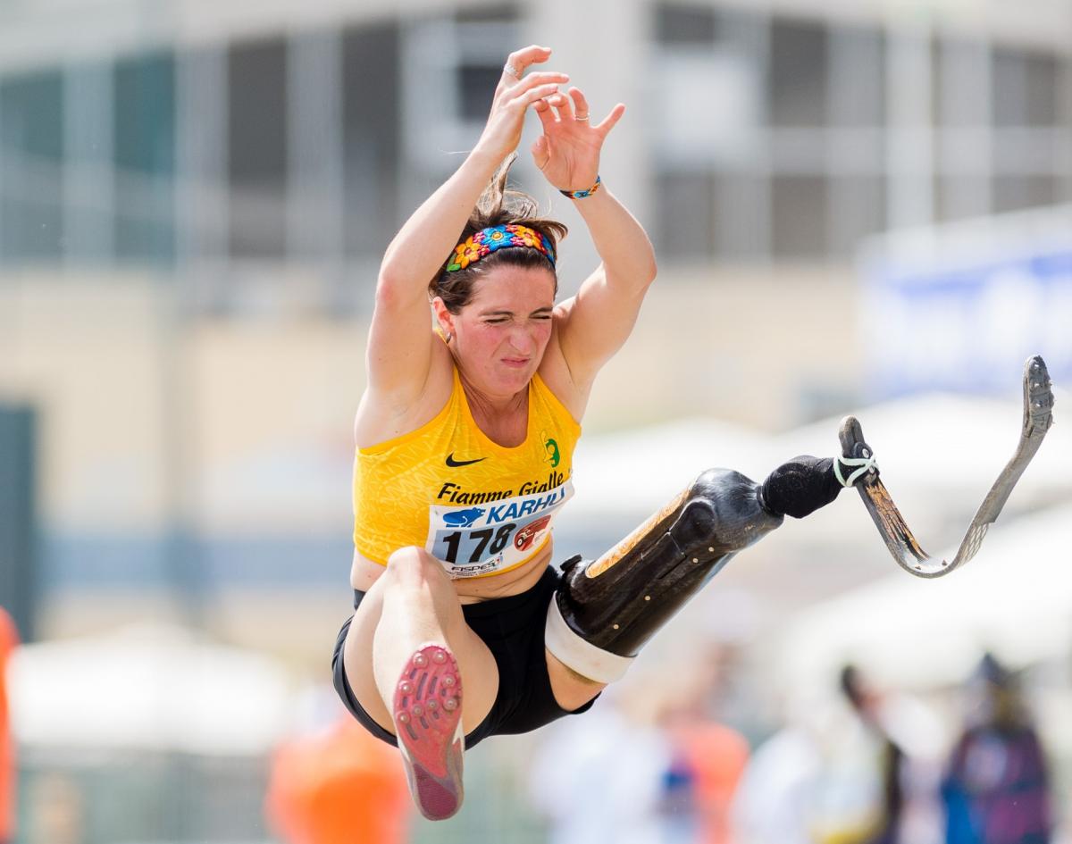 A woman with a prosthetic leg jumping