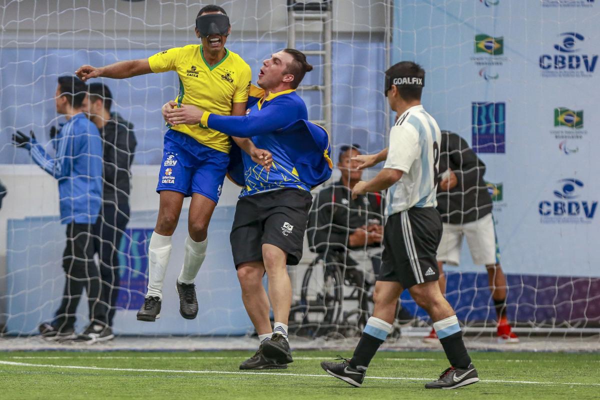 Brazil - blind football - American Championships Raimundo Nonato jumps and celebrates his goal while Argentinian defender express sadness