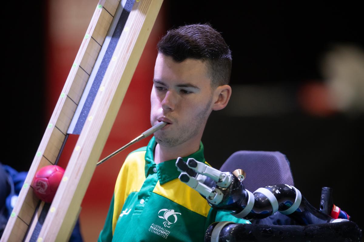 Daniel Michel - boccia - Australia Australian male boccia player holds device in mouth to push ball down ramp