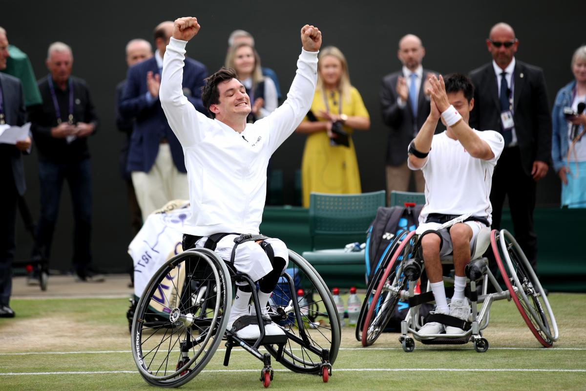 Gustavo Fernandez celebrates with his hands up while Shingo Kunieda claps in the background