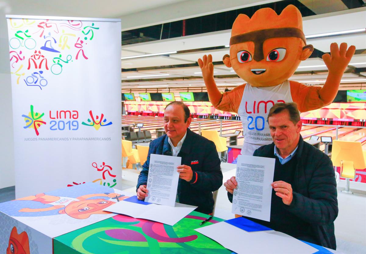 Lima 2019 - agreement to promote accessibility Lima 2019 President Carlos Neuhaus and Peruvian Ombudsman Walter Gutierrez holding the signed contracts