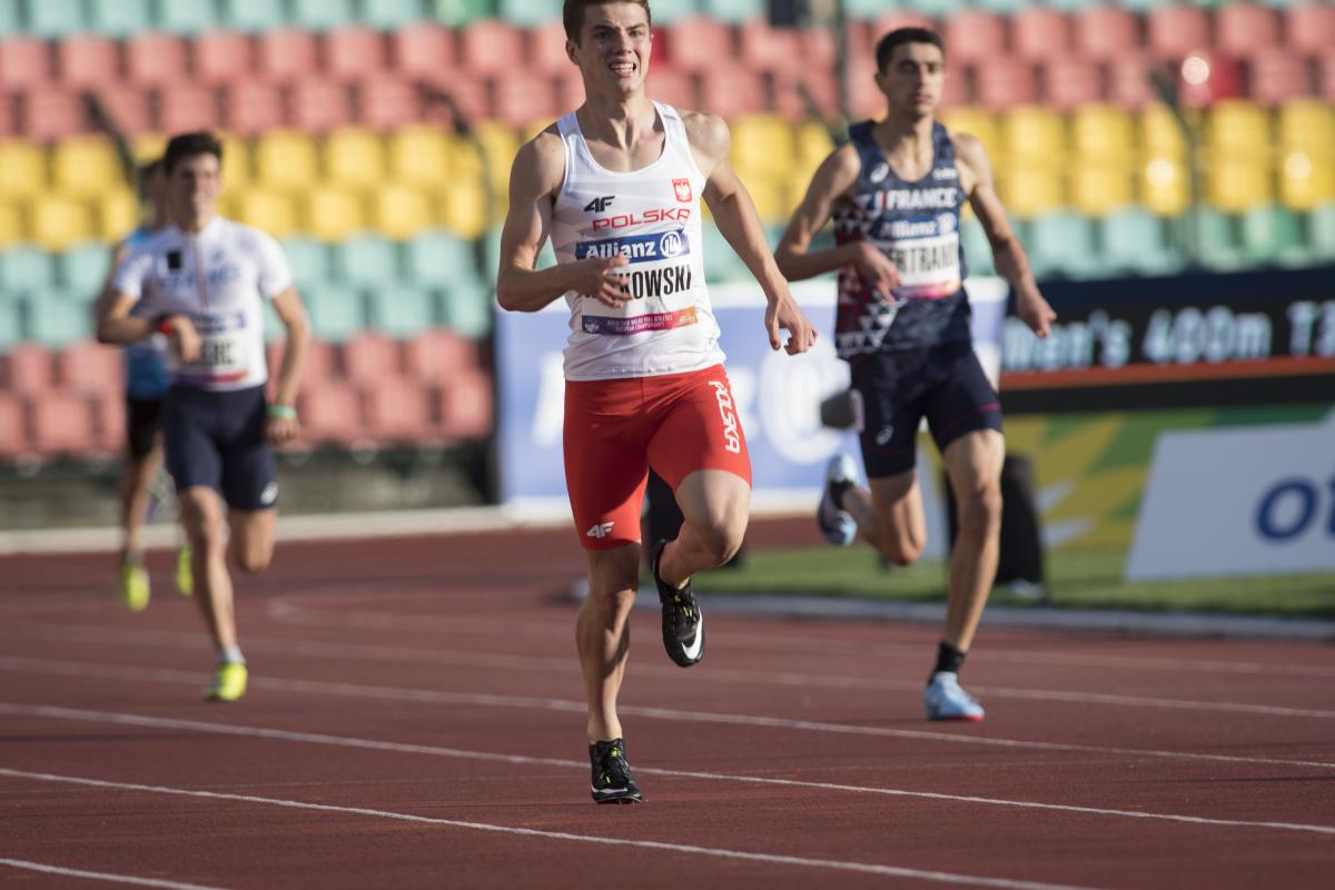 Michal Kotkowski - Poland - Berlin 2018 World Para Athletics European Championships A male sprinter runner ahead of two other competitors
