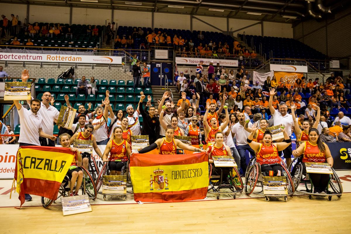 Spain - women's wheelchair basketball Spanish women's wheelchair basketball team and their staff celebrate as a group holding their hands up