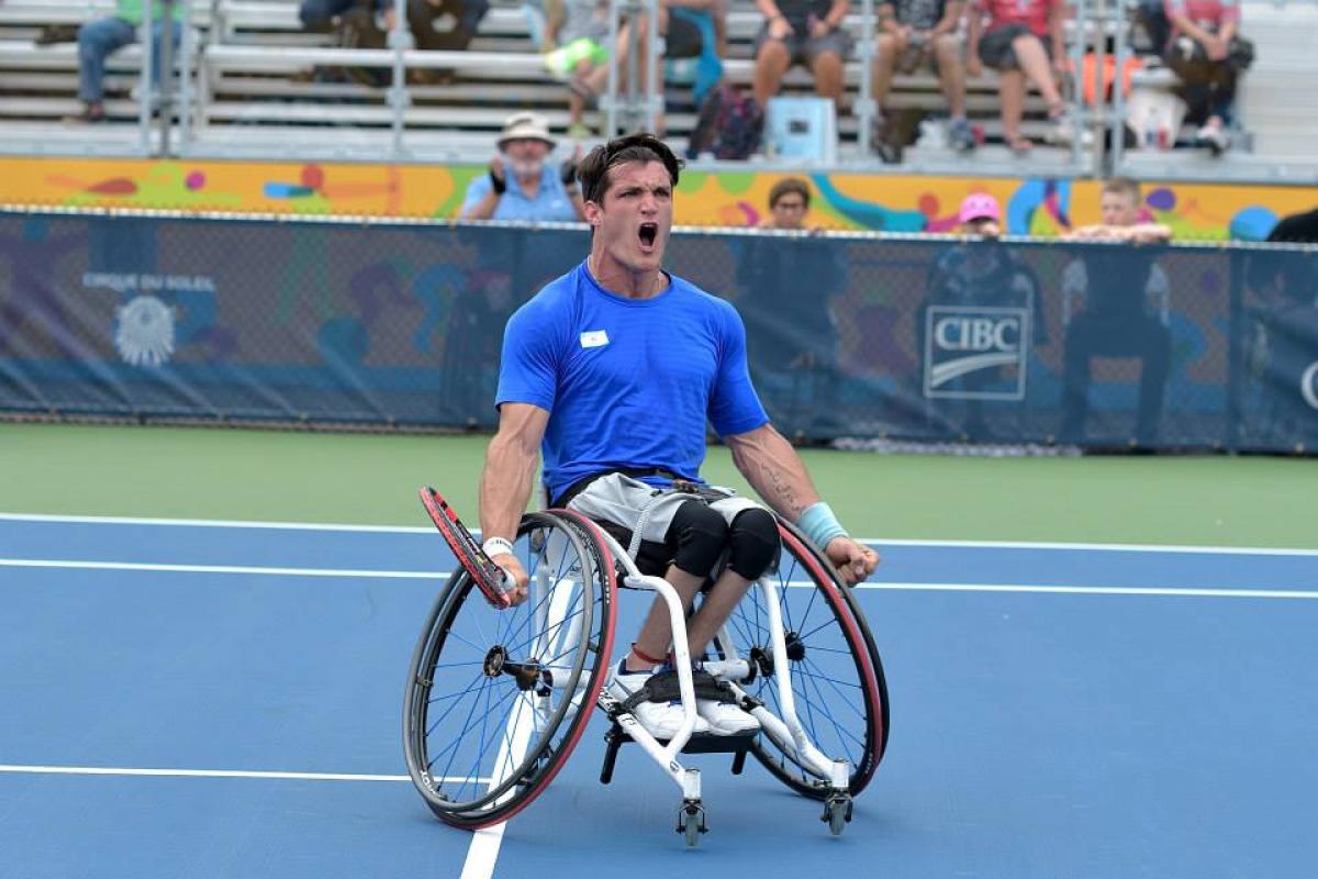 Argentinian wheelchair tennis player Gustavo Fernandez screams with joy on the court after winning gold at Toronto 2015