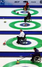 Athletes practicing Wheelchair Curling