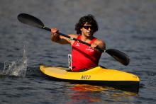 A picture of a man rowing in a Canoe