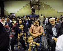 A picture of a plenty of people sitting on chairs