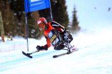 A picture of a man skiing in a special chair