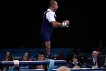 Ali Jawad of Great Britain leaps into the air after making a successful lift in the men's -56 kg Powerlifting event.