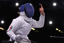 A picture of a Wheelchair Fencer celebrating her victory 