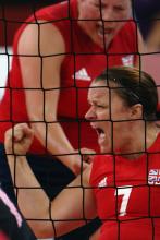 A picture of woman celebrating a point in a sitting volleyball