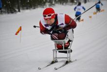 A picture of a man in a sledge skiing