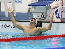 A picture of a man with his hands up in the pool