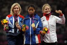 A picture of women on a podium with medals around their neck