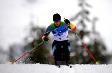 A woman in the wheelchair at the biathlon track