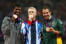 A picture of men on a podium with medals around their neck