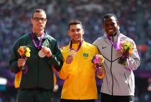 A picture of men on a podium with medals around their neck